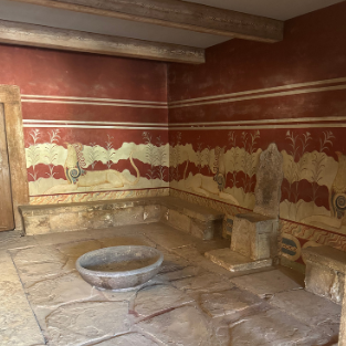 The Throne Room at Knossos, with its restored red frescoes and stone basin.